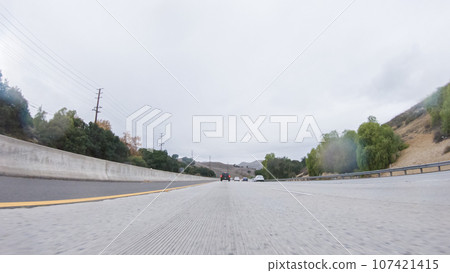 Amidst a rainy winter day, driving on HWY 134 near Los Angeles, California, captures the atmosphere through raindrop-covered lenses, adding a unique and moody perspective to the journey. Amidst a rainy winter day, driving on HWY 134 near Los Angeles, California, captures the atmosphere through raindrop-covered lenses, adding a unique and moody perspective to the journey. 107421415