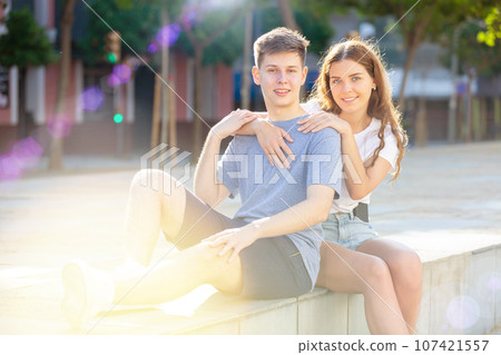 Happy boy and girl posing on city street 107421557