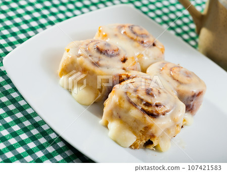 Cinnamon swirls on white plate 107421583
