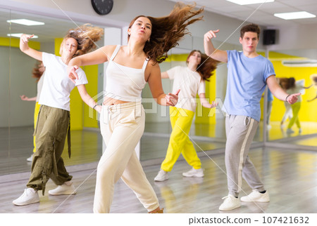 Young girl training breakdance Toprock moves in dance hall Young girl training breakdance Toprock moves in dance hall 107421632