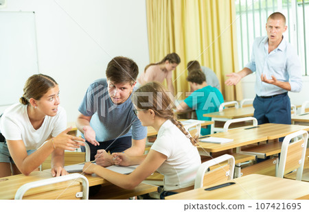 Fellow students having group work tasks during school 107421695