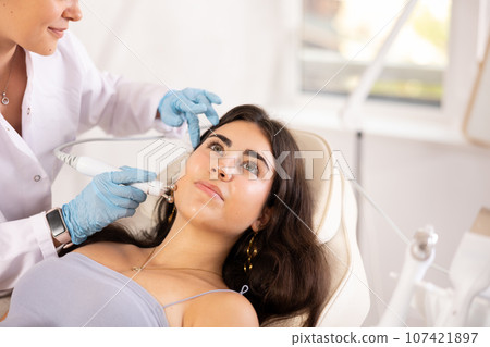 Facial Beauty massage to brunette girl Facial Beauty massage to brunette girl 107421897