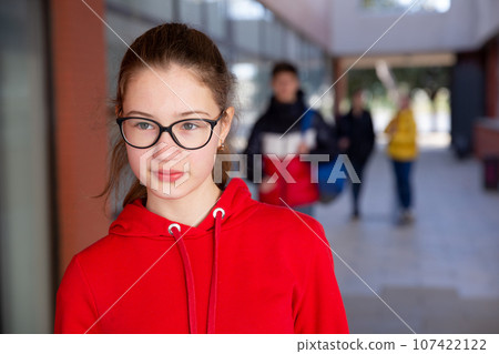 Teen girl in glasses walking to college 107422122