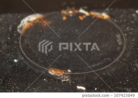 A black dirty electric stove. closeup . 107423849