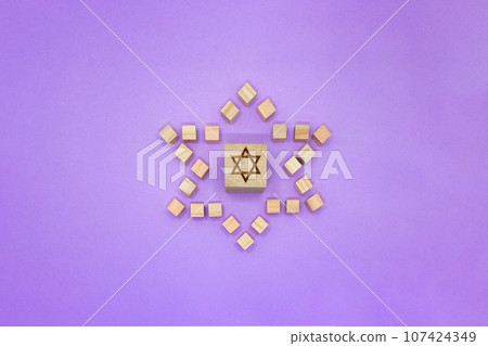 Front view of purple background of wood cubes with hexagram motif 107424349