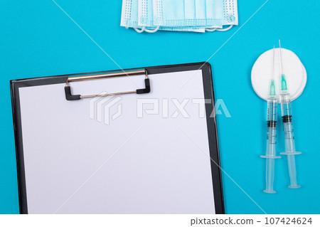 Vaccination or Revaccination Concept - Two Medical Syringe on Blue Table 107424624
