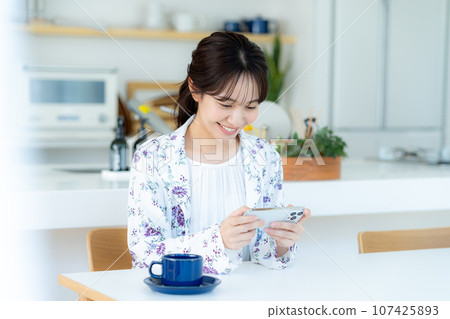 A young woman operating a smartphone A young woman operating a smartphone 107425893