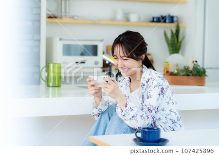 A young woman operating a smartphone A young woman operating a smartphone 107425896