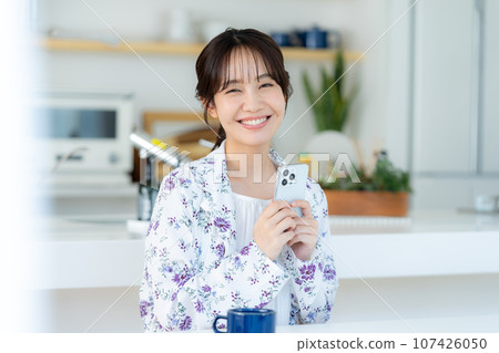 A young woman operating a smartphone A young woman operating a smartphone 107426050