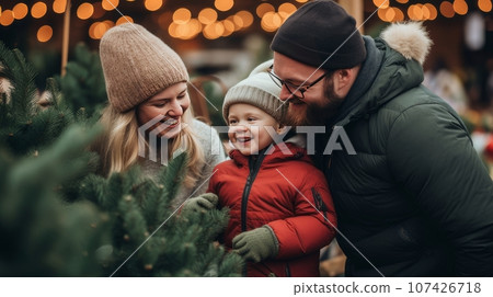 A happy family with a child with Down syndrome and parents choose a New Year's A happy family with a child with Down syndrome and parents choose a New Year's 107426718