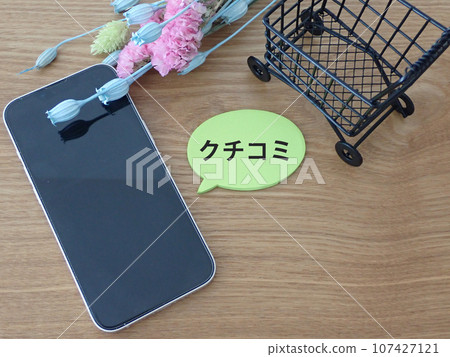 Speech bubble on smartphone, review text and shopping cart Speech bubble on smartphone, review text and shopping cart 107427121