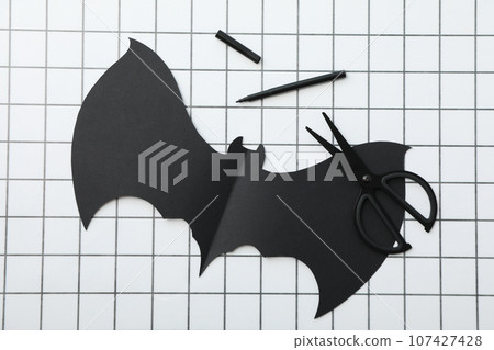 Scissors and paper bat on light background, top view Scissors and paper bat on light background, top view 107427428