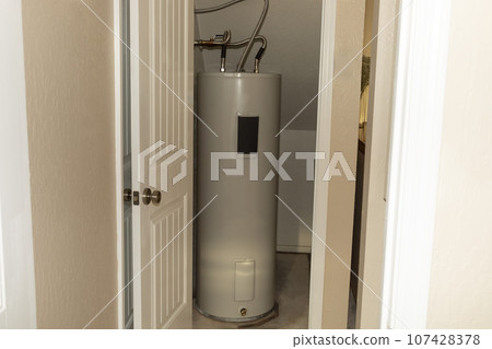 Automatic Storage Water Heater 75 Gal In Storeroom. Modern Electric Boiler, Water Tank in Storehouse In House. Horizontal Plane 107428378