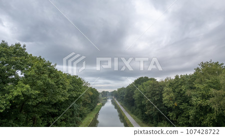 Nature's Serenity: Canal Amidst Verdant Forest 107428722