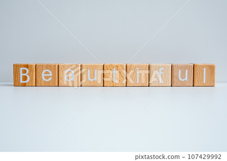 Wooden blocks form the text "Beautiful" against a white background. Wooden blocks form the text "Beautiful" against a white background. 107429992