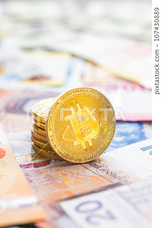 Bitcoin on various banknotes background. Bitcoin on various banknotes background. 107430889