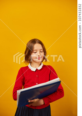 Thoughtful School teenage girl holding pen and write on notebook 107431832