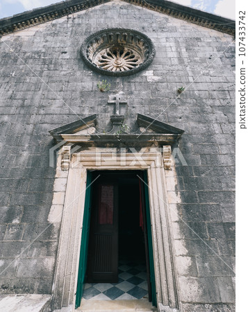 Open wooden door to an ancient stone temple Open wooden door to an ancient stone temple 107433742
