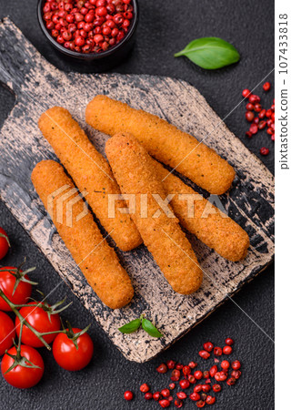 Delicious crispy cheese sticks with mozzarella, salt and spices, breaded and fried in oil Delicious crispy cheese sticks with mozzarella, salt and spices, breaded and fried in oil 107433818