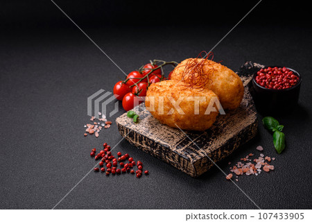 Delicious baked potato cutlet stuffed with chicken and vegetables, spices and salt 107433905