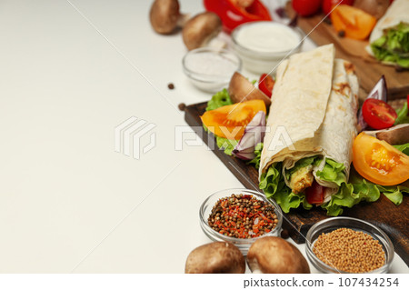 Tasty fast or homemade food concept - delicious shawarma Tasty fast or homemade food concept - delicious shawarma 107434254