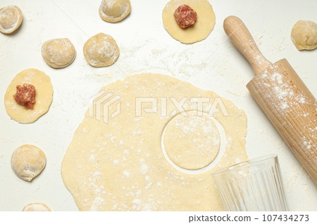 Cooking home food concept with raw dumplings Cooking home food concept with raw dumplings 107434273
