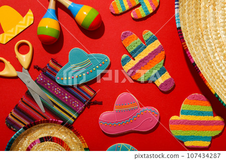 Mexican maracas, cactus and sombrero on color background Mexican maracas, cactus and sombrero on color background 107434287