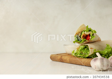 Tasty fast or homemade food concept - delicious shawarma Tasty fast or homemade food concept - delicious shawarma 107434538