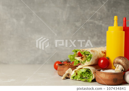 Tasty fast or homemade food concept - delicious shawarma Tasty fast or homemade food concept - delicious shawarma 107434841