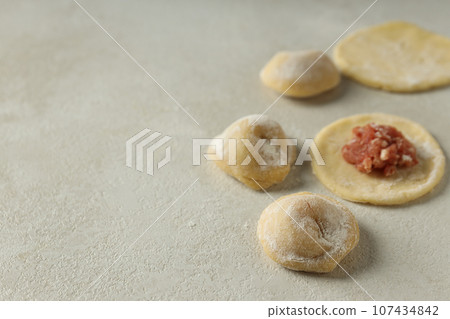 Cooking home food concept with raw dumplings Cooking home food concept with raw dumplings 107434842