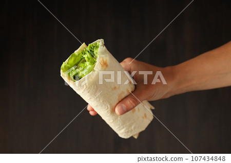 Tasty fast or homemade food concept - delicious shawarma Tasty fast or homemade food concept - delicious shawarma 107434848