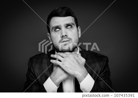 A man in a zombie costume on a black background 107435391