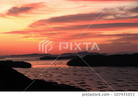A superb view of the sky, sea and islands dyed golden in the morning sun A superb view of the sky, sea and islands dyed golden in the morning sun 107435853