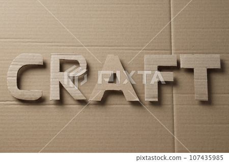 The word "CRAFT" is cut out of cardboard. The word "CRAFT" is cut out of cardboard. 107435985