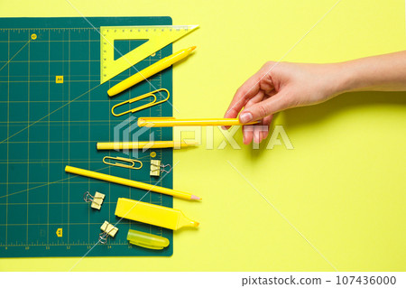 Patchwork accessories concept on yellow background, mat cutting 107436000