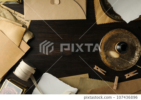Vintage letters, golden plate and ink bottle on wooden background, space for text Vintage letters, golden plate and ink bottle on wooden background, space for text 107436896