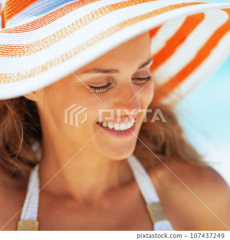 happy young woman in hat on beach happy young woman in hat on beach 107437249