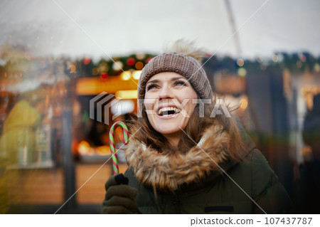 happy modern woman at christmas fair in city happy modern woman at christmas fair in city 107437787