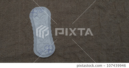 Ladies hygienic daily pads on brown background Ladies hygienic daily pads on brown background 107439946