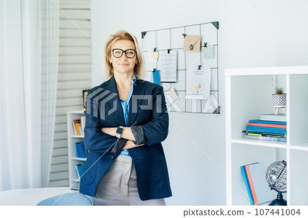 Smiling middle aged businesswoman near grid mood board with pinned work-life balance wheel diagram on her work space. Finding Balance in Your Life. Life planning. Coaching tools. Selective focus Smiling middle aged businesswoman near grid mood board with pinned work-life balance wheel diagram on her work space. Finding Balance in Your Life. Life planning. Coaching tools. Selective focus 107441004