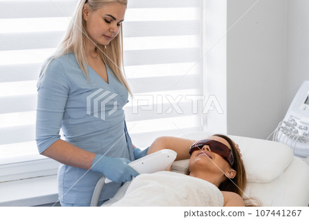 Thorough care of a cosmetologist and photoepilation on the way to perfect skin. Feel the atmosphere of caring care in the beauty salon. Cosmetic care: removal of hair under the paths Thorough care of a cosmetologist and photoepilation on the way to perfect skin. Feel the atmosphere of caring care in the beauty salon. Cosmetic care: removal of hair under the paths 107441267