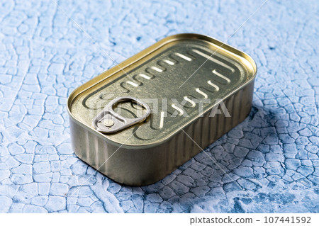 Canned food in metal can on blue background 107441592