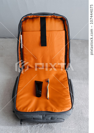 Minimalist travel, minimalism to trip, packing light, traveling with only the essentials. Minimalist Travel Capsule Wardrobe. Carry-on only packing list. Only toothbrush and toothpaste in the suitcase 107444075
