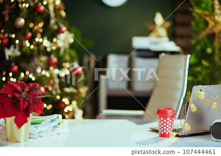 modern Christmas decorated green office with laptop 107444461