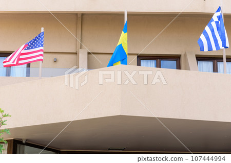 flags on balcony of building in Chania. USA, Sweden, Greece flags. flags on balcony of building in Chania. USA, Sweden, Greece flags. 107444994