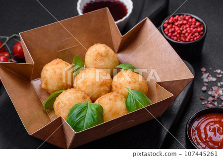 Delicious round balls of mozzarella and parmesan cheese with salt and breaded spices Delicious round balls of mozzarella and parmesan cheese with salt and breaded spices 107445261