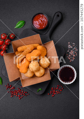 Delicious nuggets, sticks and balls of mozzarella and parmesan cheese with salt and spices 107445279