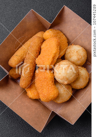 Delicious nuggets, sticks and balls of mozzarella and parmesan cheese with salt and spices Delicious nuggets, sticks and balls of mozzarella and parmesan cheese with salt and spices 107445289