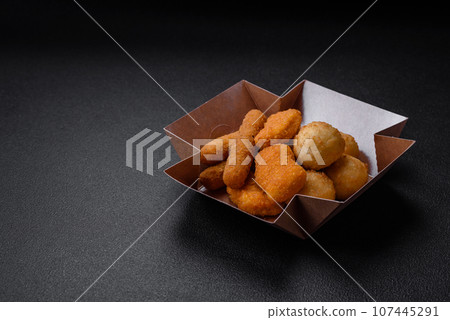 Delicious nuggets, sticks and balls of mozzarella and parmesan cheese with salt and spices Delicious nuggets, sticks and balls of mozzarella and parmesan cheese with salt and spices 107445291