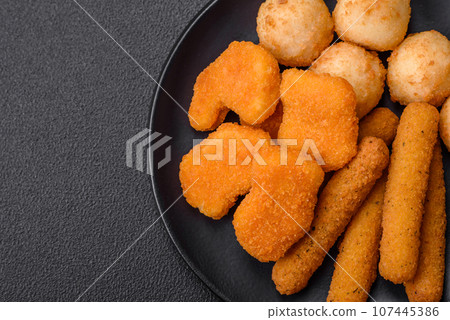 Delicious nuggets, sticks and balls of mozzarella and parmesan cheese with salt and spices 107445386